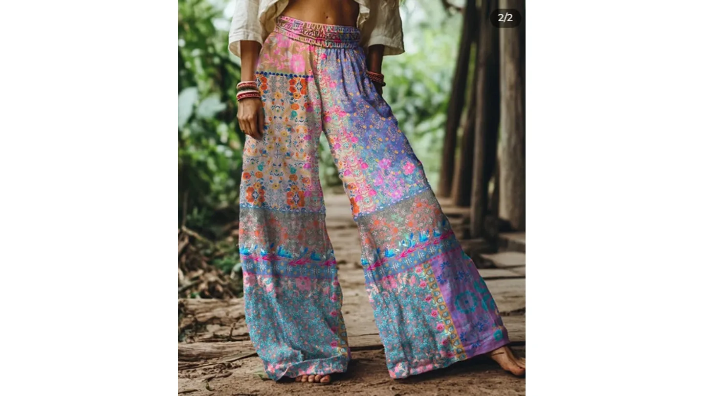 A person wearing wide-leg floral print pants with an elastic waistband.