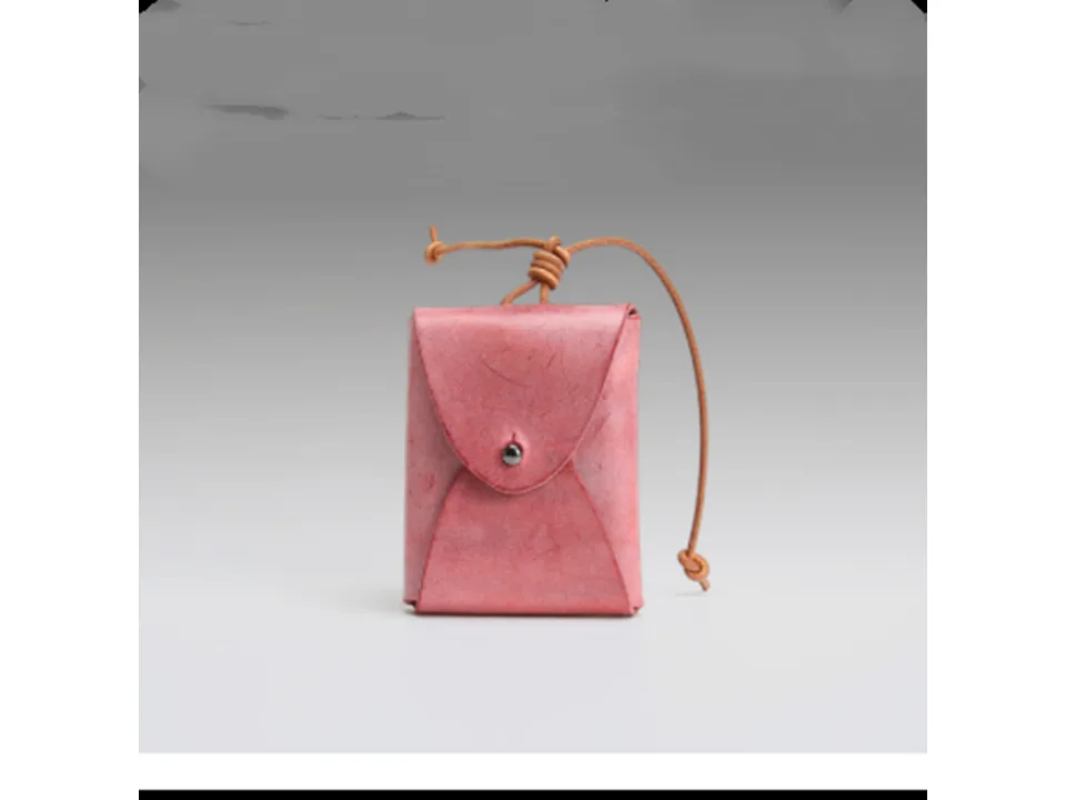 A small red leather coin purse with a drawstring closure.