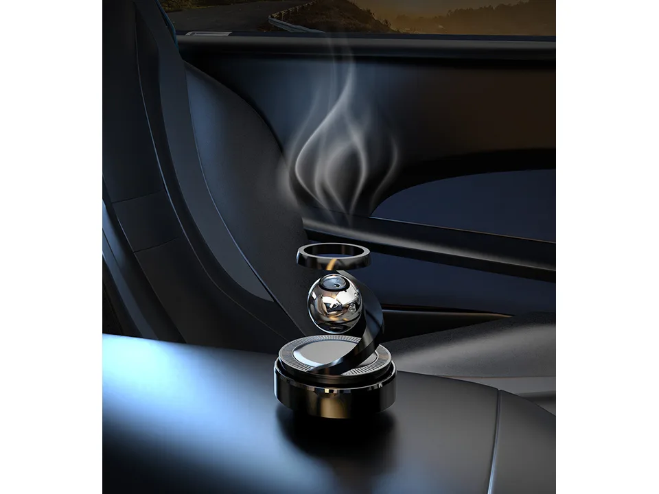 Solar powered car aromatherapy diffuser sitting on a car center console.