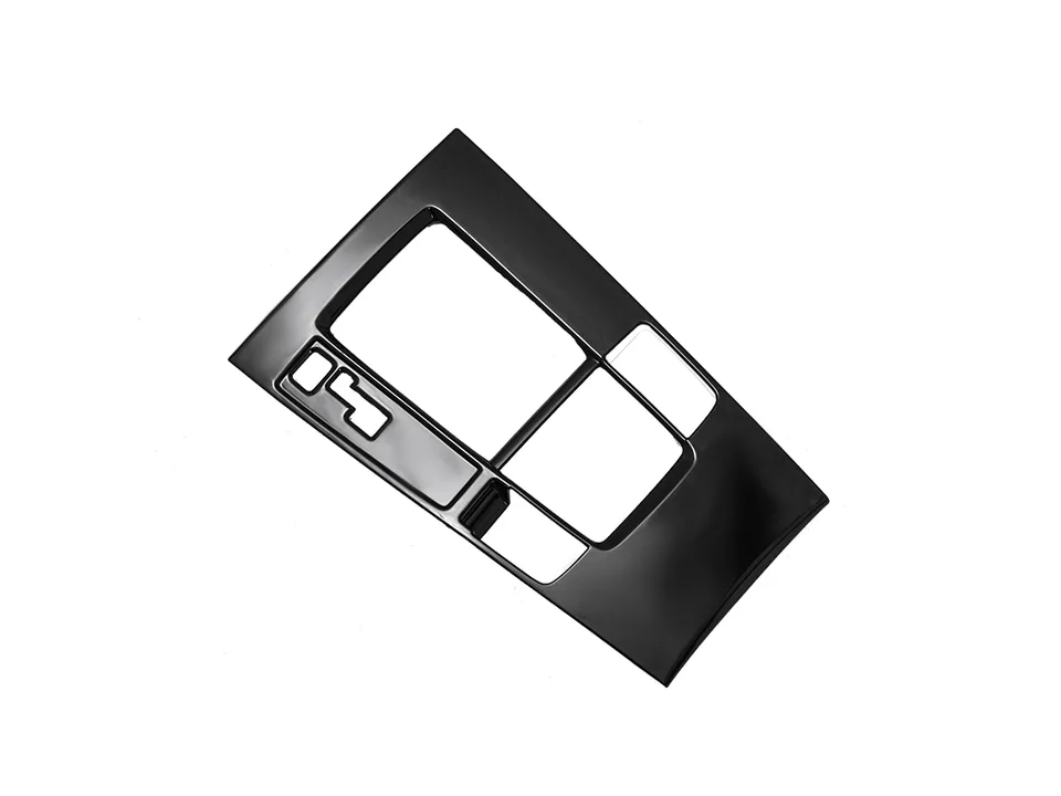 A black interior trim cover piece for a car gear shift console.