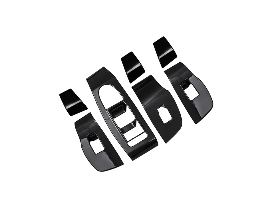 A set of black interior trim covers for car door window switches.