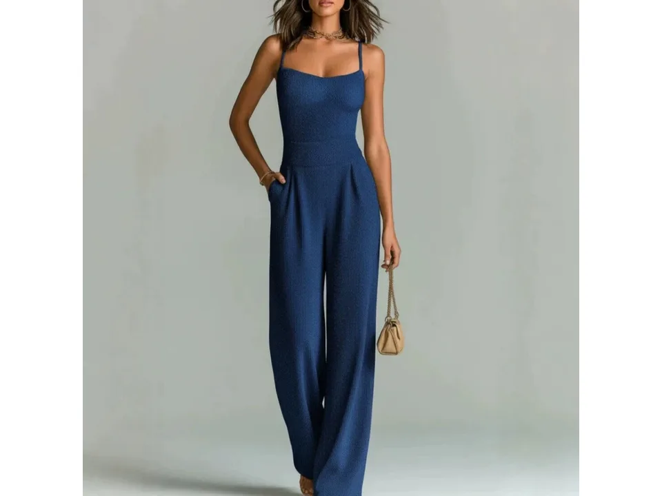 A woman wearing a sleeveless blue ribbed wide-leg jumpsuit.