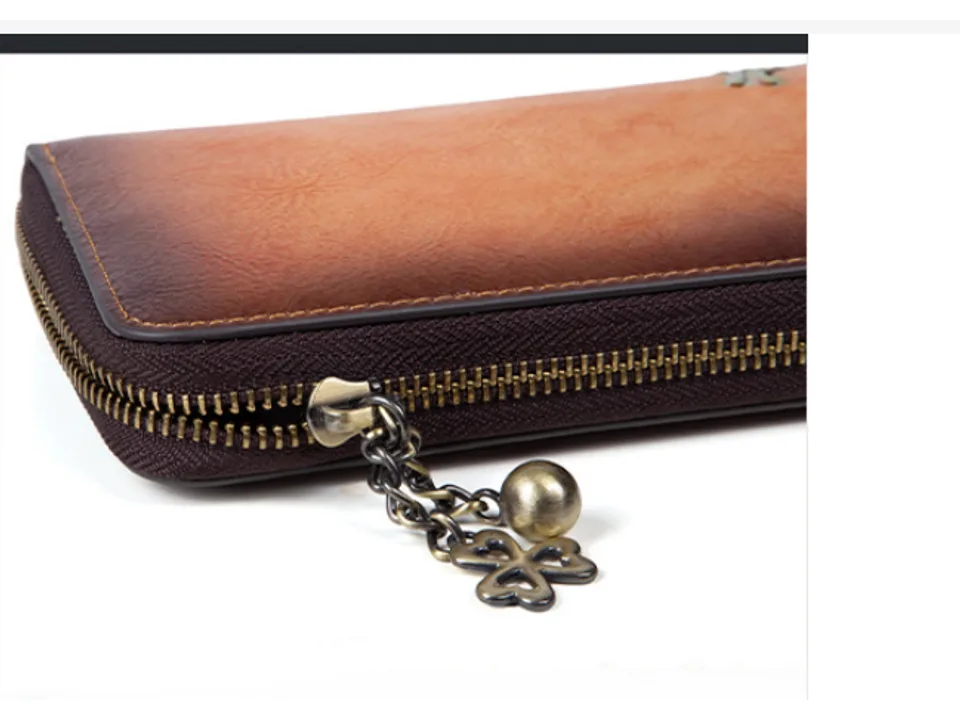 Close-up of the wallet zipper and clover-shaped charm.