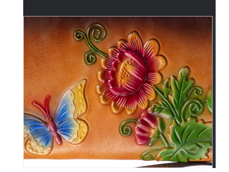 Close-up of the embossed butterfly and flower design on the leather wallet.