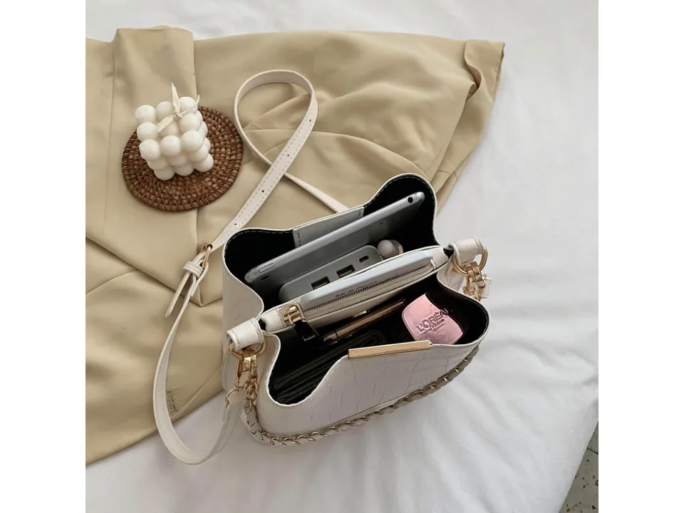 Interior view of the white bucket bag filled with personal items.