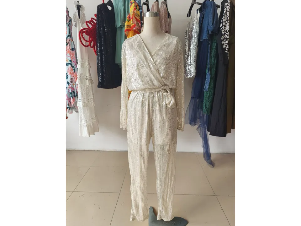 A silver sequin jumpsuit on a mannequin.