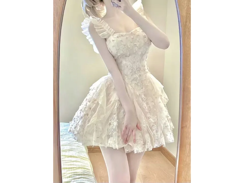 A person wearing the floral mini dress, seen in a mirror.