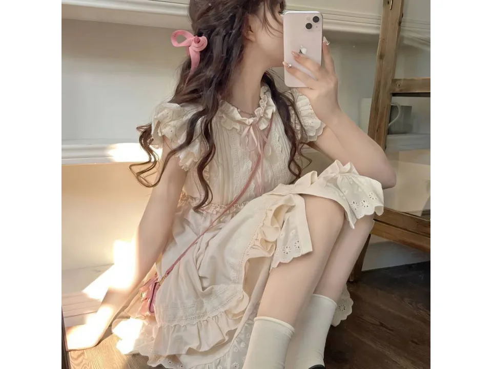 A person wearing the floral mini dress while sitting.