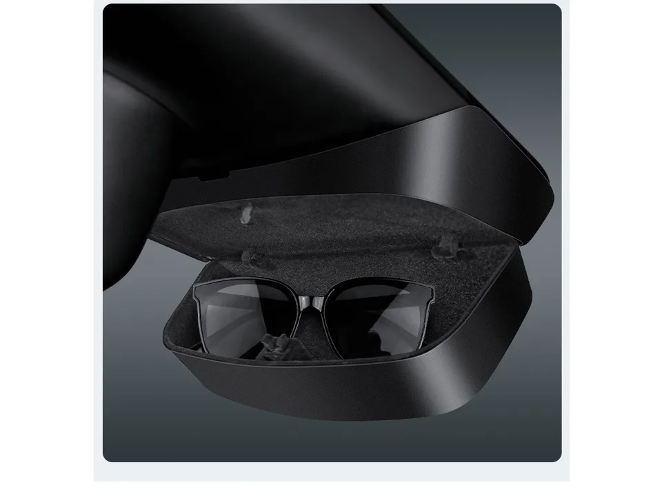 Open car glasses storage box with a pair of sunglasses inside.