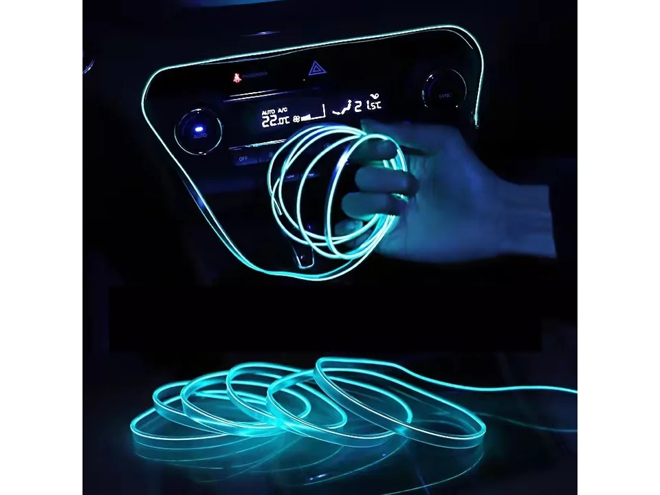 Car interior ambient LED light strip installed in a dashboard, glowing blue.