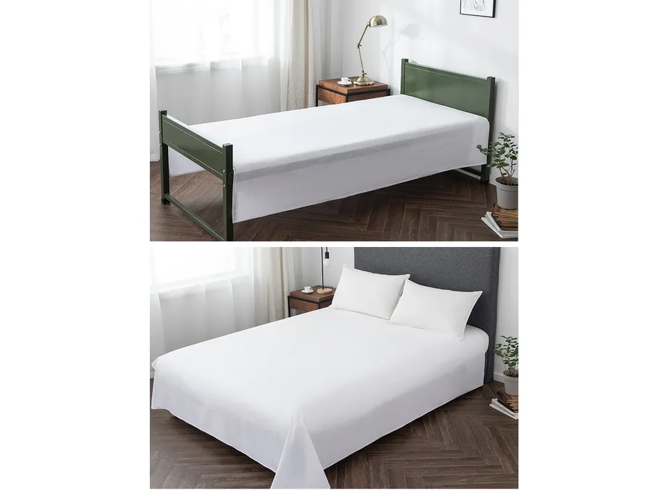 A white flat sheet on a bed in a bedroom setting.