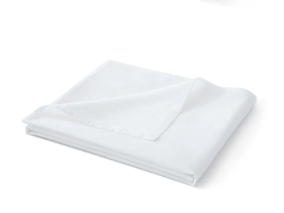 A folded white bed sheet showing the hem detail.