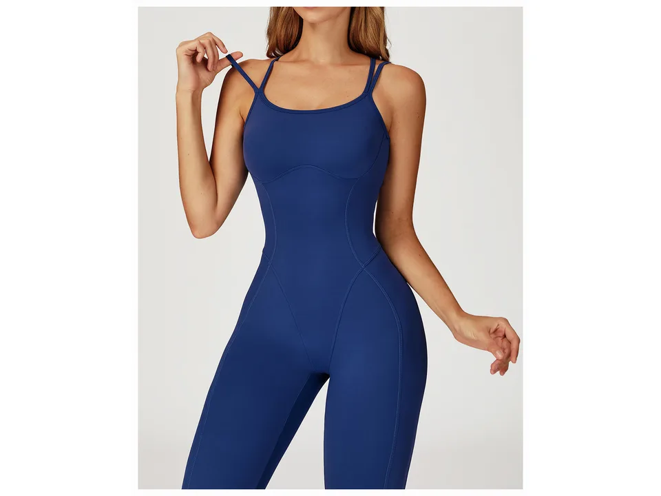 A model wearing the blue yoga jumpsuit, showing the fit.