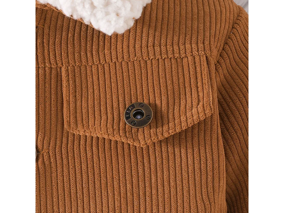 Close-up of the brown corduroy fabric and a metal button on the chest pocket.