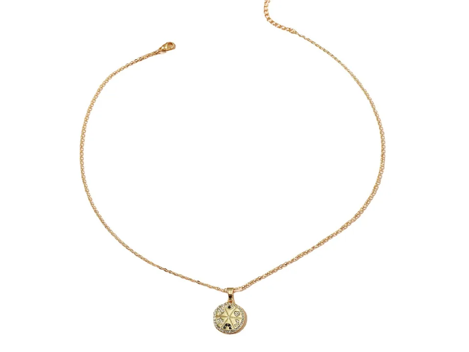Full view of the gold chain necklace with a circular celestial pendant.