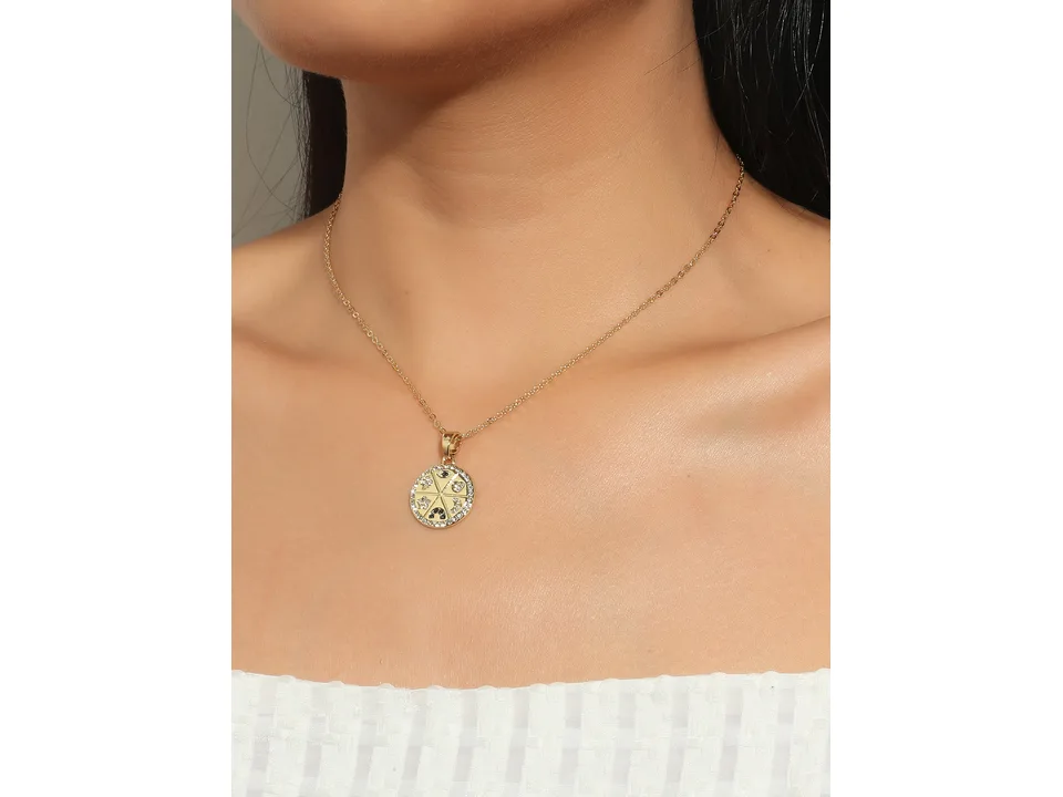 A woman wearing the gold celestial pendant necklace.
