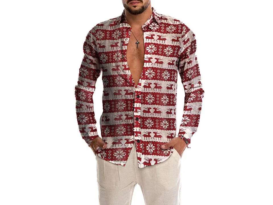 A man wearing a long-sleeved button-down shirt with a red and white reindeer and snowflake pattern.