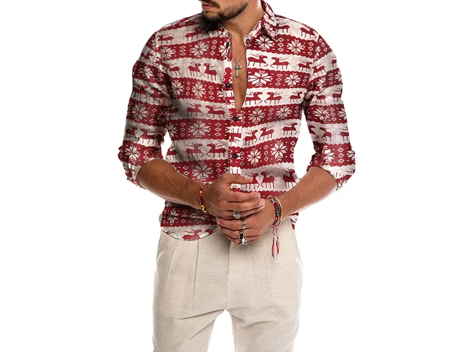 Close-up of a man wearing a button-down shirt with a festive reindeer and snowflake print.