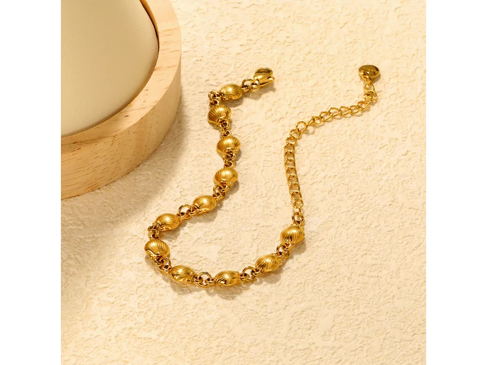 Gold-tone charm bracelet with shell-shaped charms.