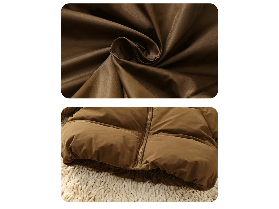 Close-up of the brown puffer jacket fabric and bottom zipper detail.