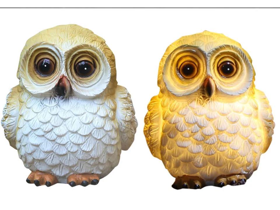 Two owl garden lamps, one unlit and one glowing with warm light.