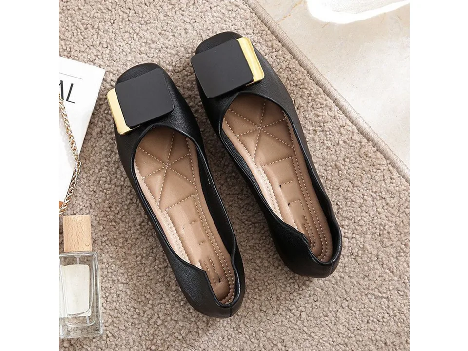 Top-down view of a pair of black square toe flat loafers with gold-tone metal buckles.