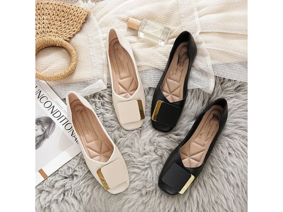Two pairs of square toe flat loafers, one beige and one black, arranged on a textured rug.
