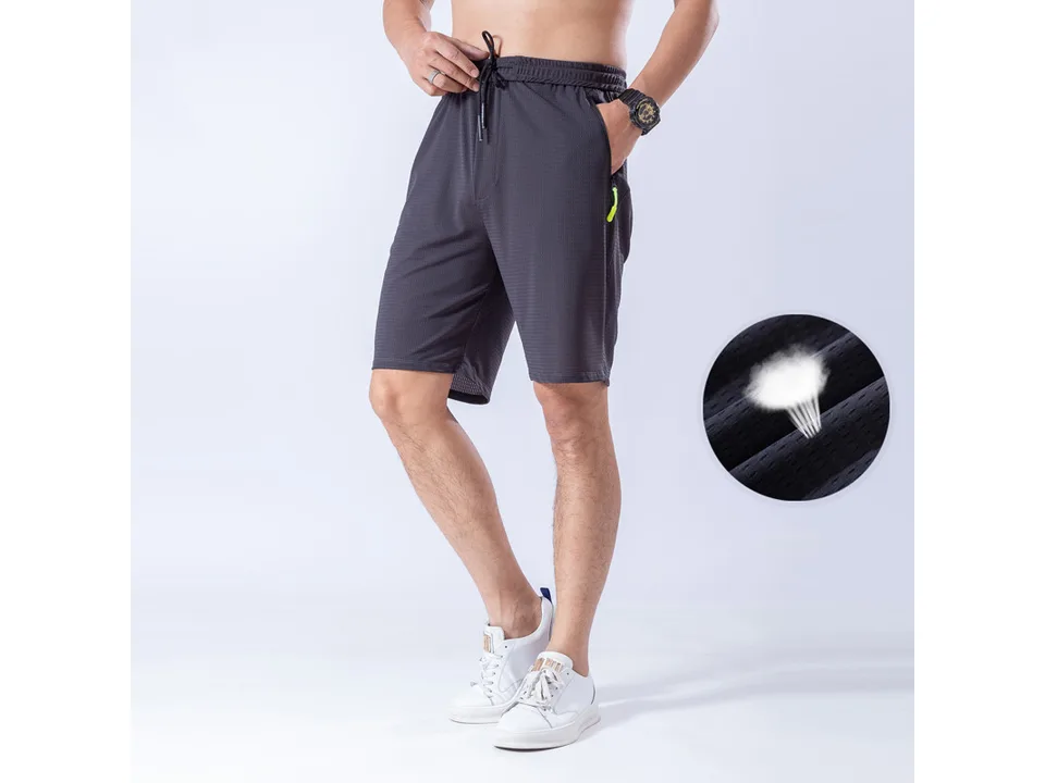 Man wearing dark grey athletic shorts with a close-up inset showing the breathable fabric.