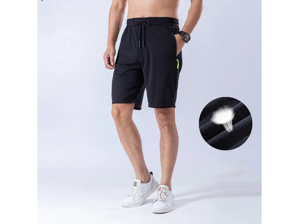 Man wearing black athletic shorts with a close-up inset showing the breathable fabric.