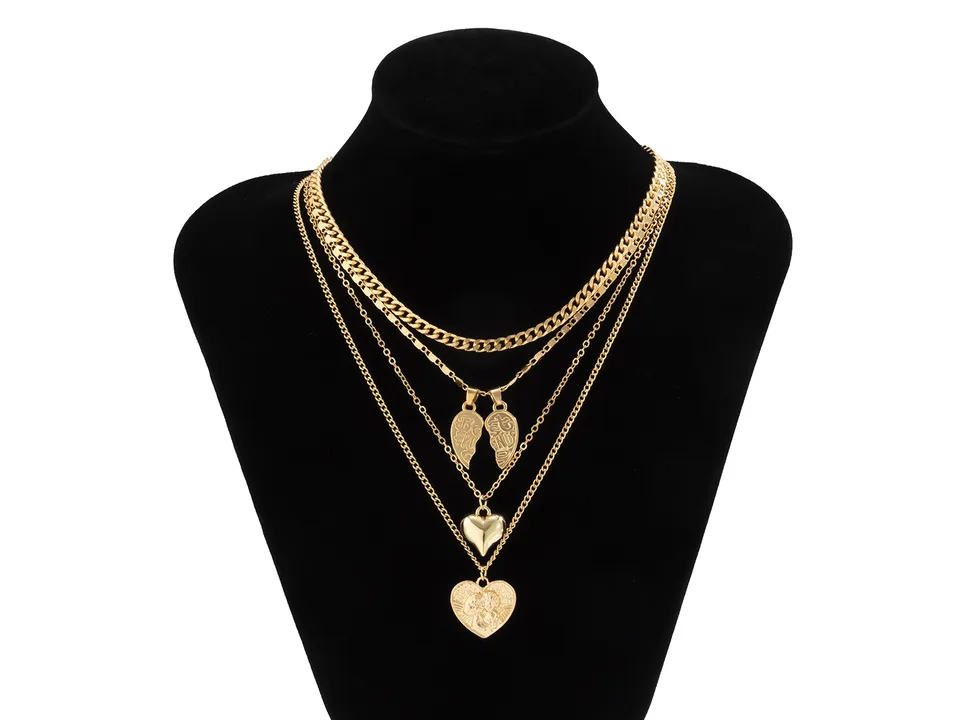 Gold multi-layer heart pendant necklace set displayed on a black mannequin bust.