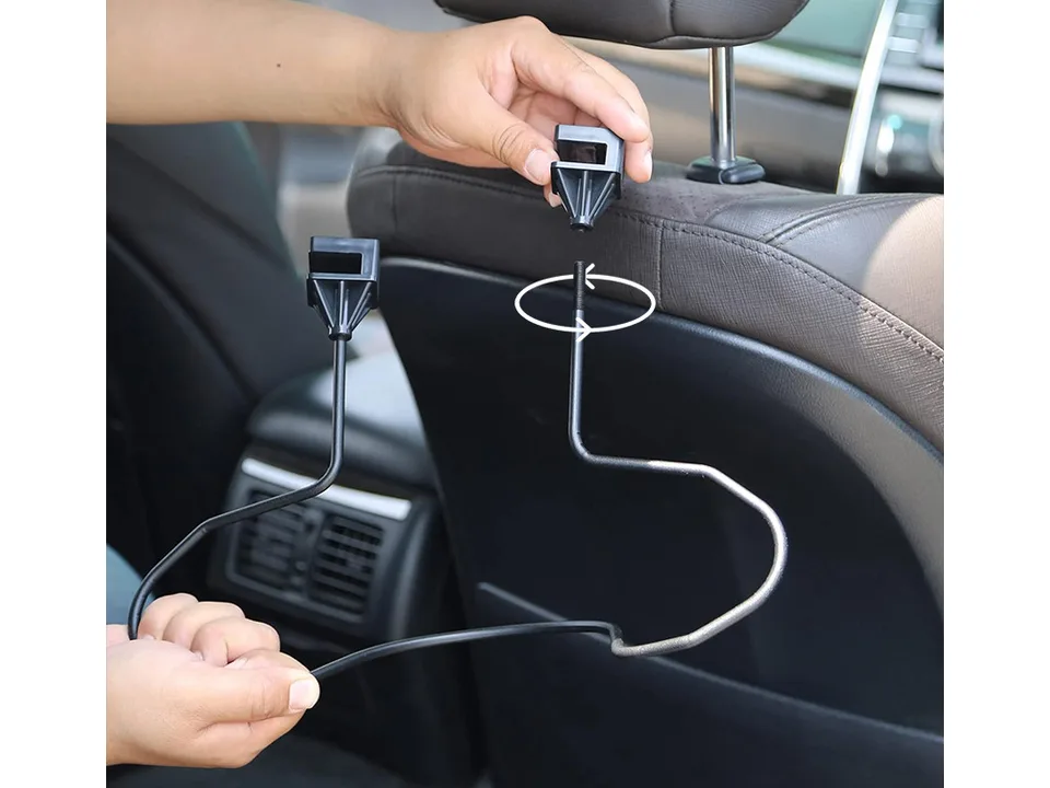 Hands assembling the car headrest hat hanger.
