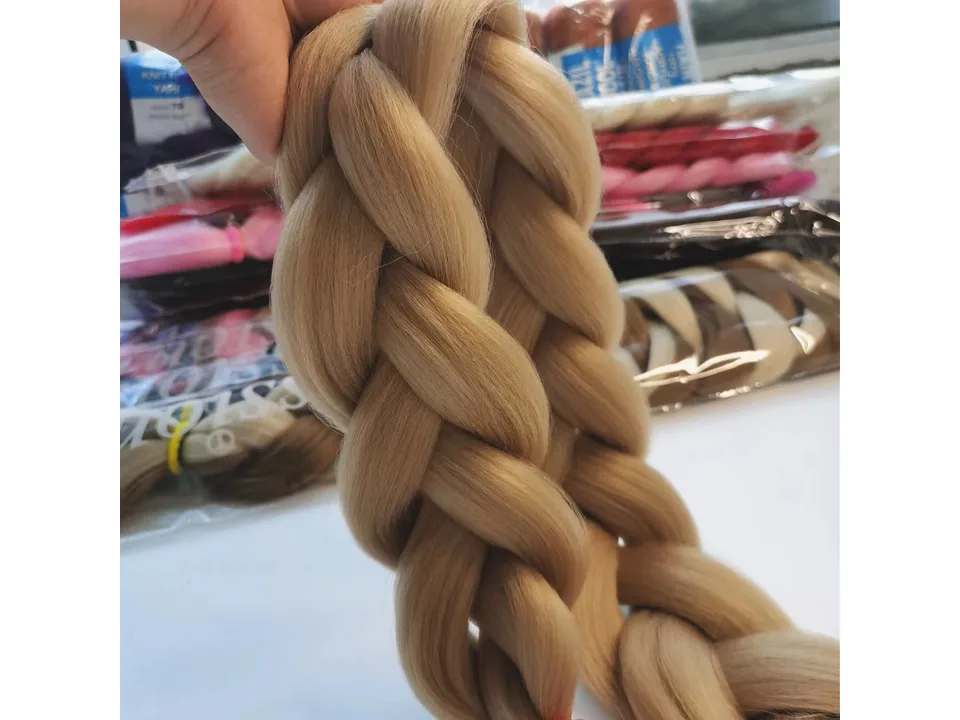 Close-up of a blonde synthetic hair braid extension.