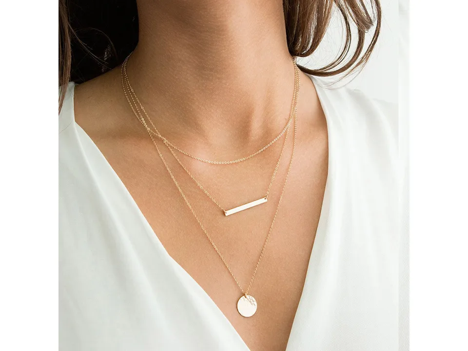 A woman wearing the gold multi-layer necklace.