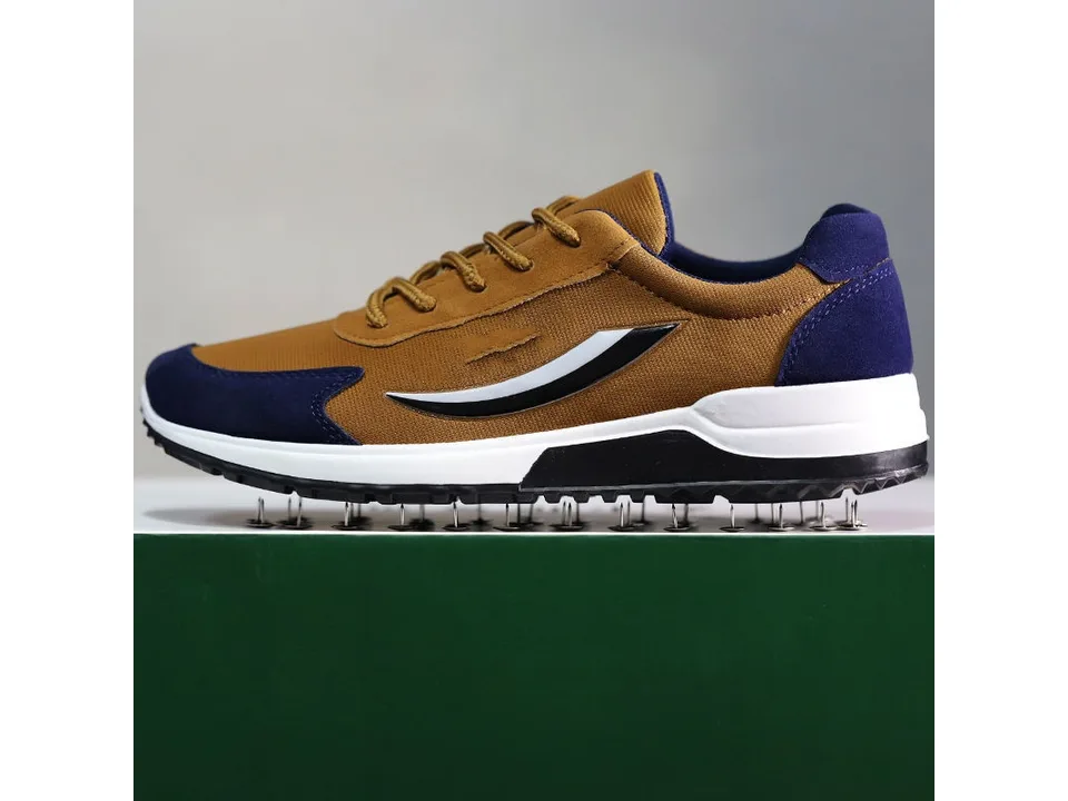 Side view of a brown and blue sneaker.