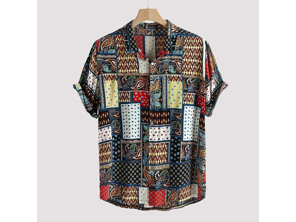A men's short-sleeve button-down shirt with a colorful vintage patchwork print, shown on a hanger.
