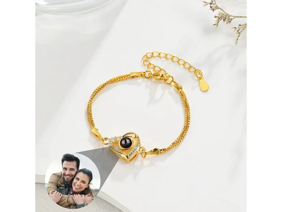 Gold heart projection bracelet with a circular photo projection showing a couple.
