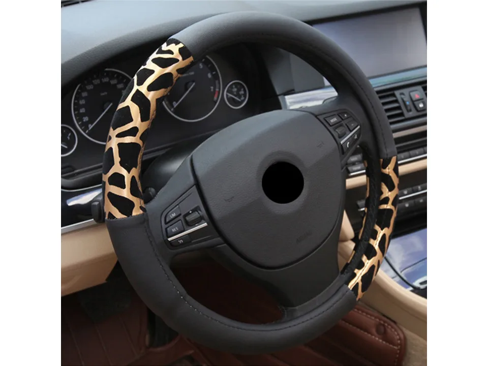 Gold and black animal print steering wheel cover installed on a car steering wheel.