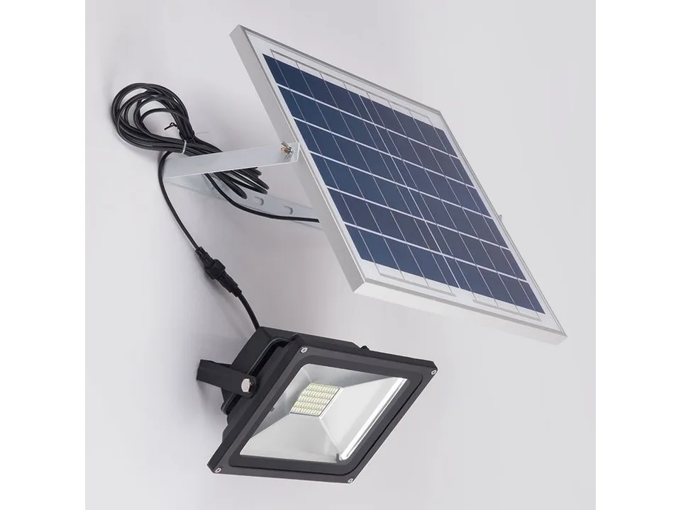 Solar floodlight connected to its solar panel.