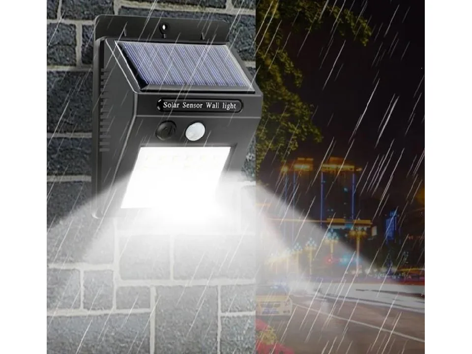 Solar powered LED wall light mounted on a brick wall, illuminated at night.