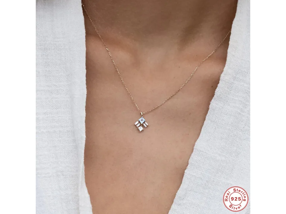 A woman wearing the gold pendant necklace, showing how it sits on the neck.