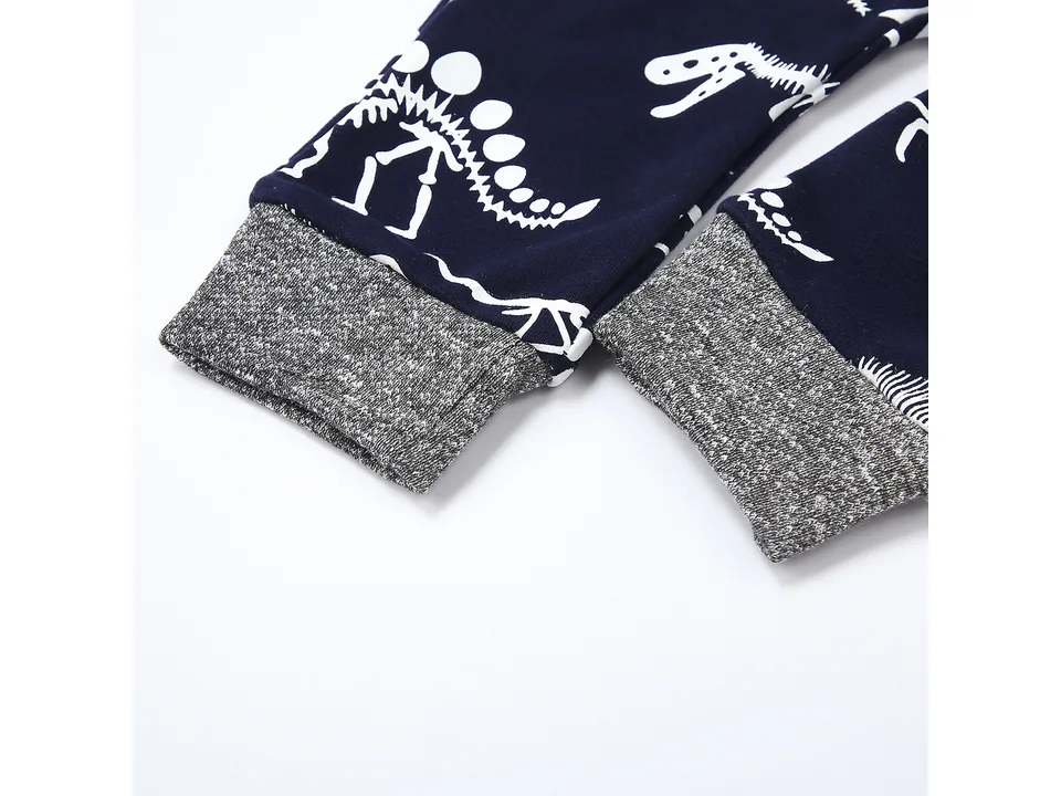 Close-up of the dinosaur print pants cuffs.