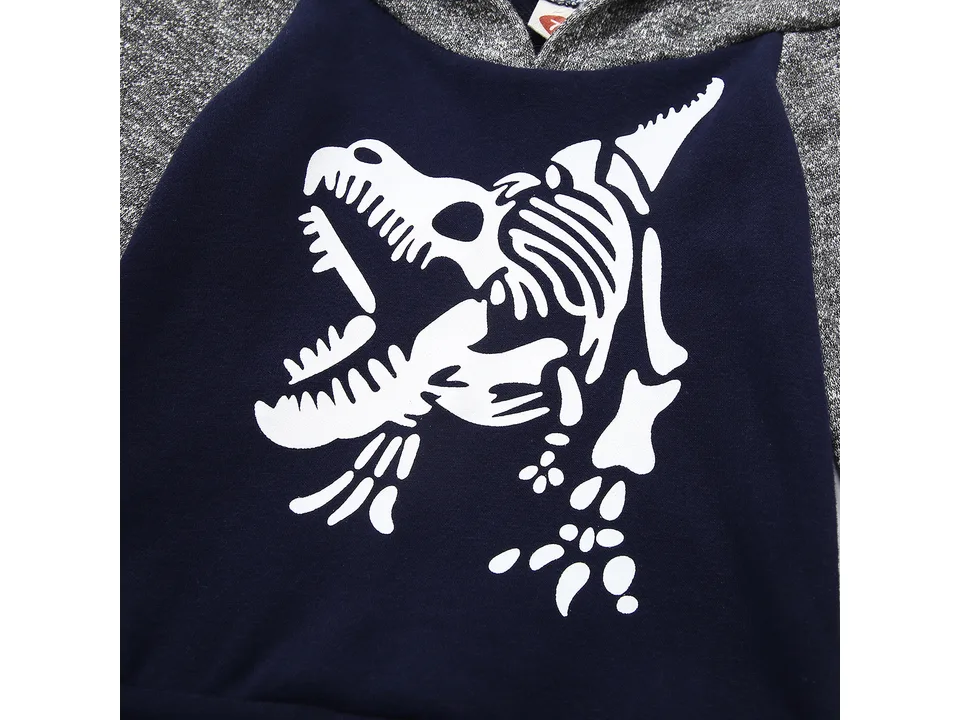 Close-up of the dinosaur skeleton graphic on the sweatshirt.
