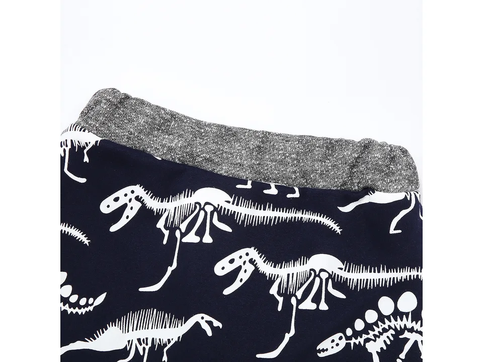 Close-up of the elastic waistband on the dinosaur print pants.