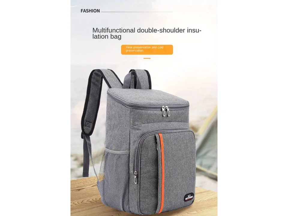 Grey insulated cooler backpack sitting on a wooden table outdoors.