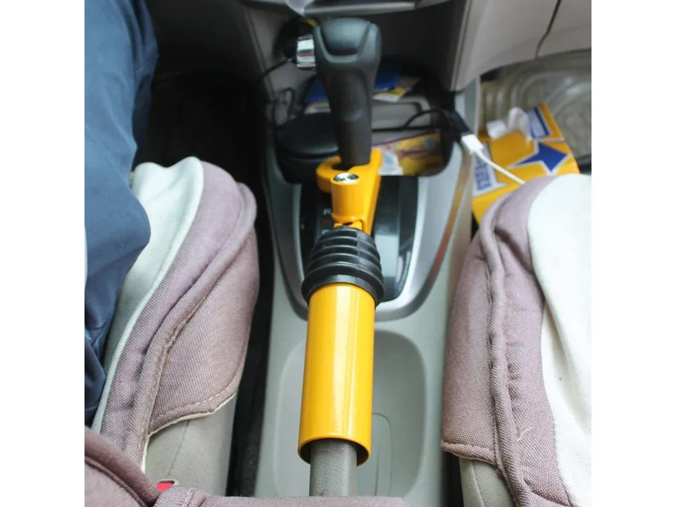 Yellow vehicle gear shift security lock installed in a car.