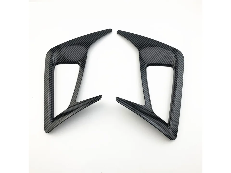 Pair of carbon fiber style rear fog lamp frame trims on a white background.
