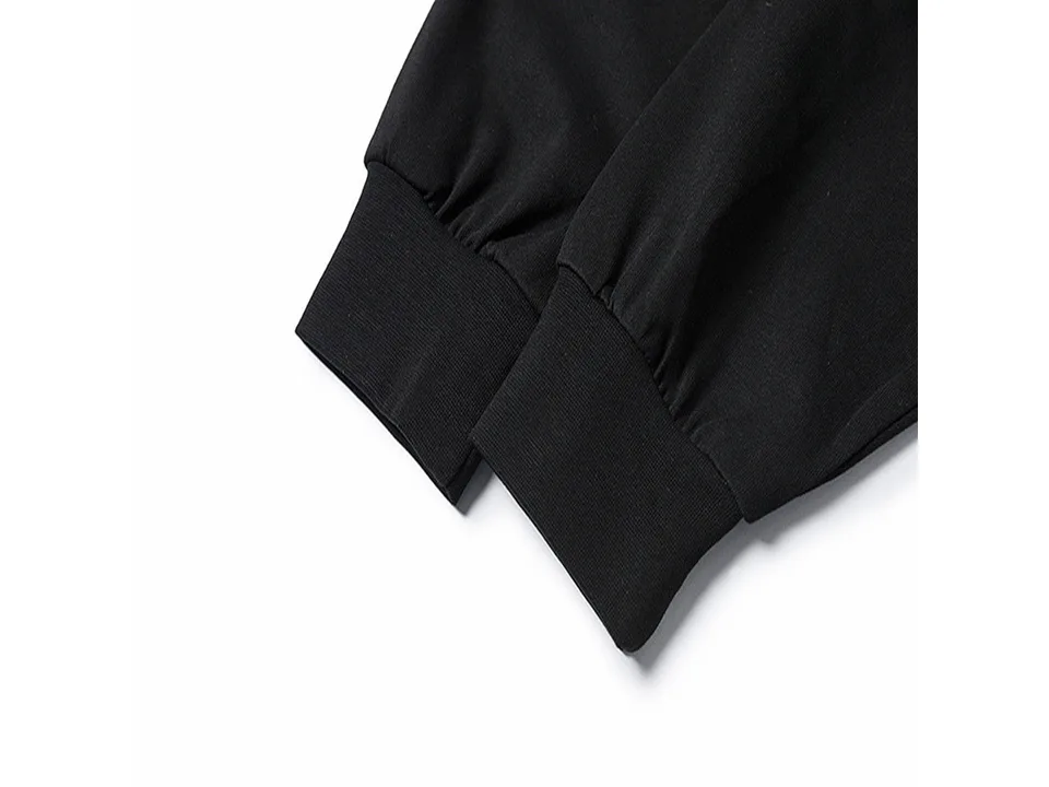 Close-up of the black ribbed cuff on the sleeve of the sweatshirt.