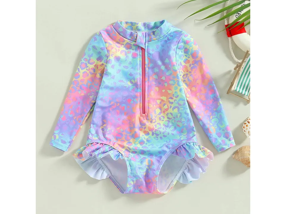 Front view of a colorful, long-sleeve toddler swimsuit with a zipper and ruffle detail.