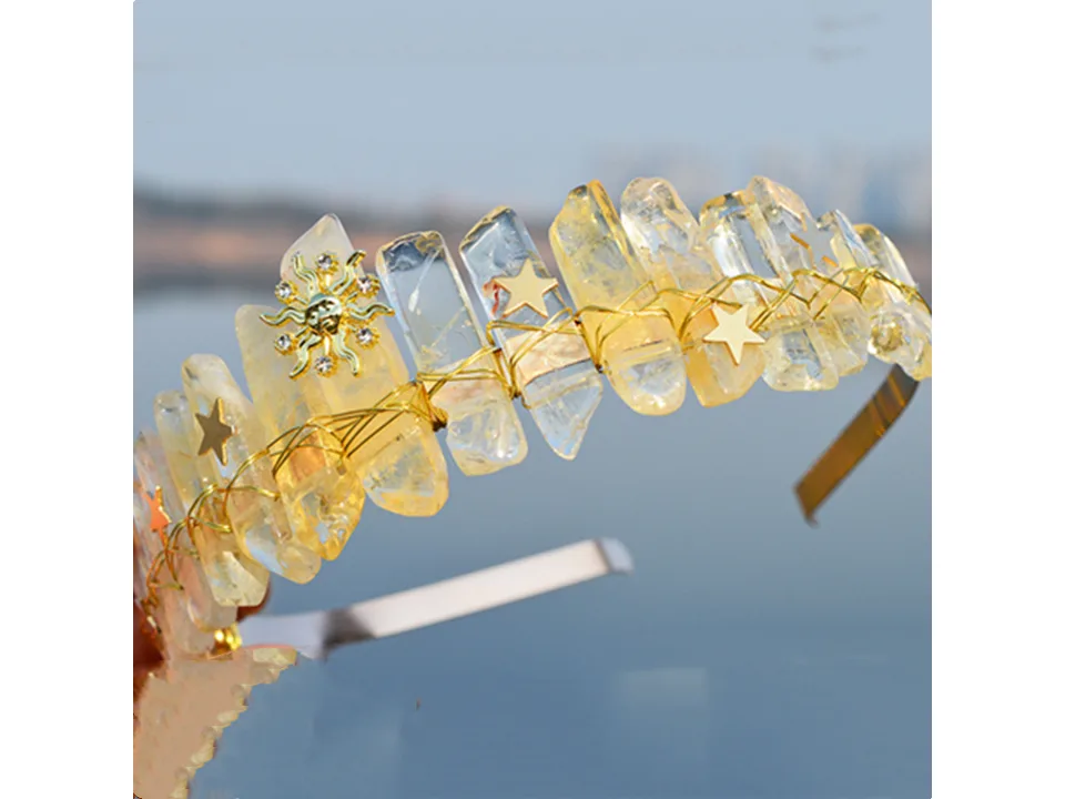 A yellow crystal crown headband with sun and star charms.