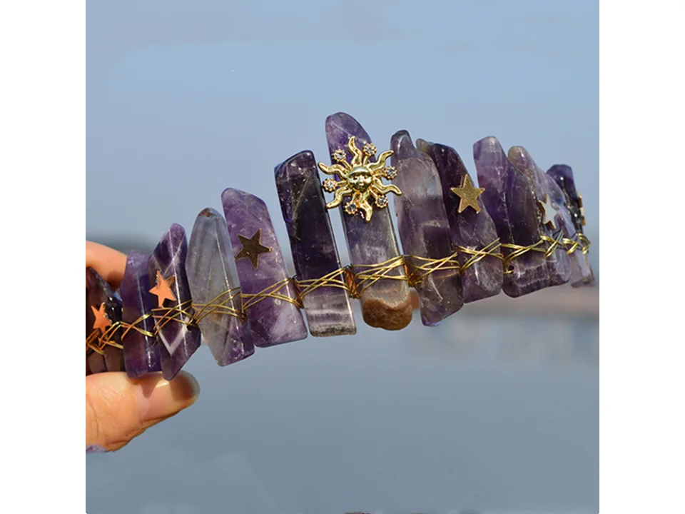 A purple crystal crown headband with sun and star charms.